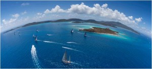 The fleet of 20 superyachts sails past Necker Island on Race Day Three. Photo by Carlo Borlenghi